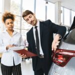 Professionnels examinent un véhicule dans un showroom lumineux